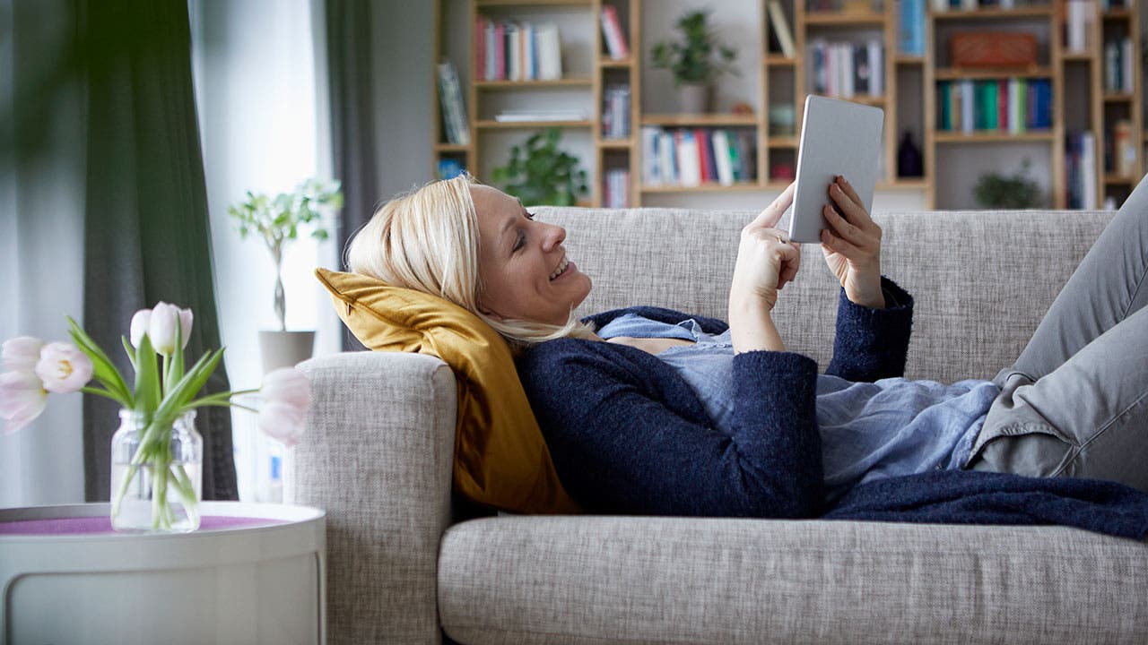 Woman using tablet on couch