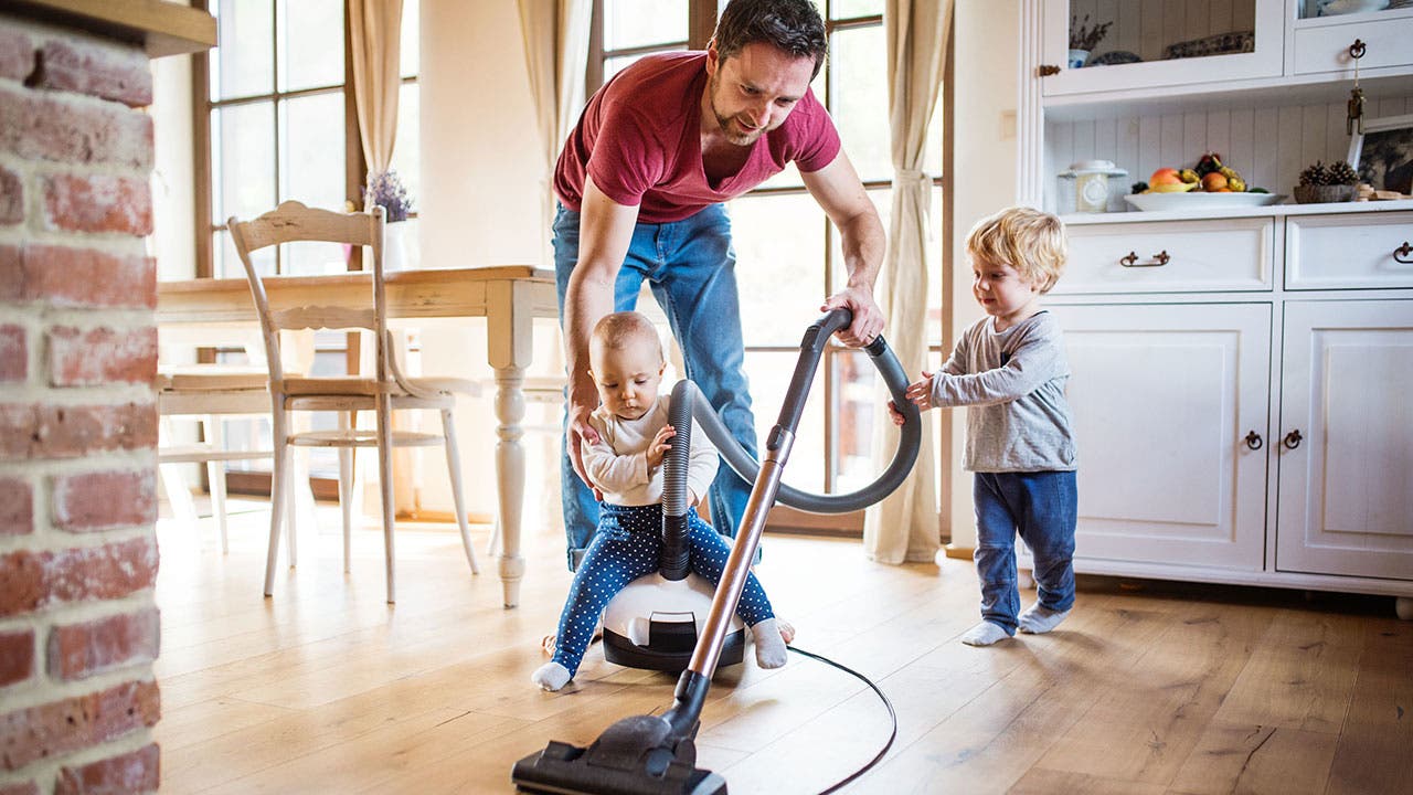 Father and sons vaccuming