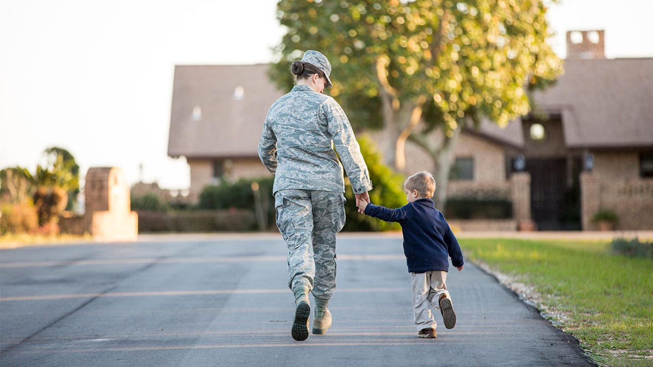 Military member walking with child