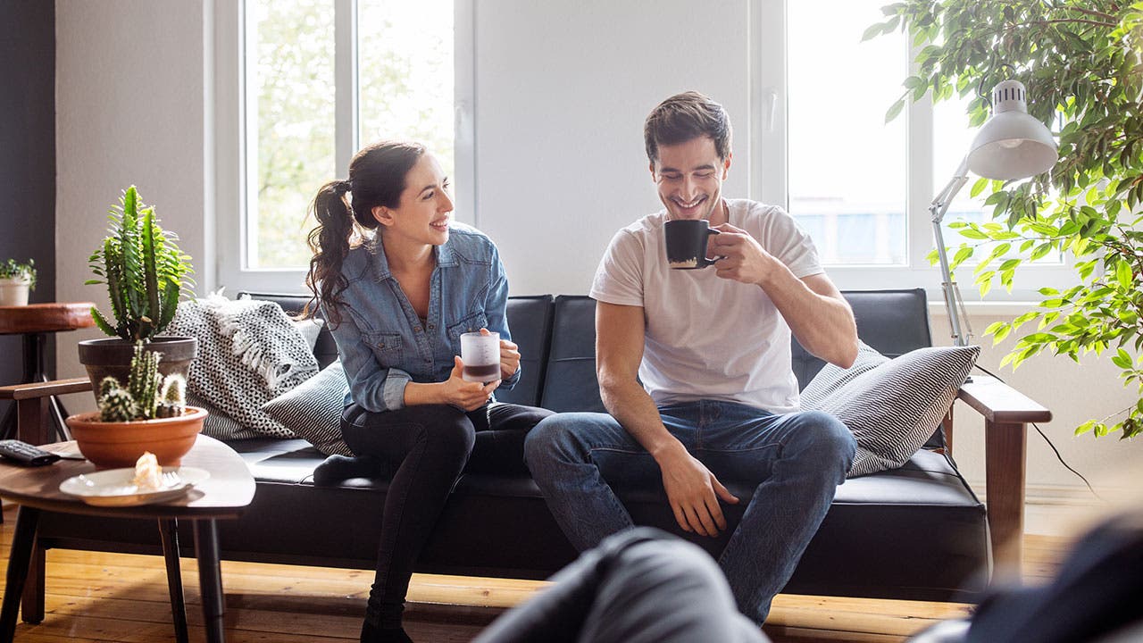 Couple drinking coffee in livingroom