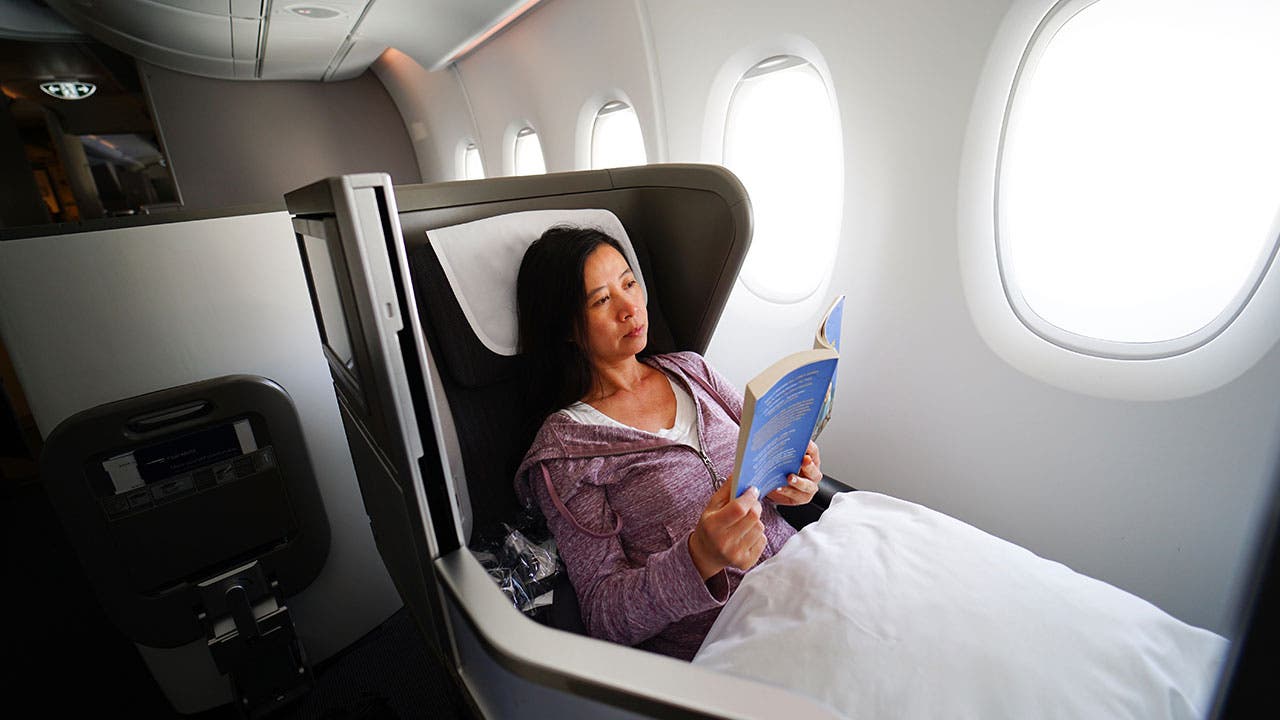 Woman reading on first class plane