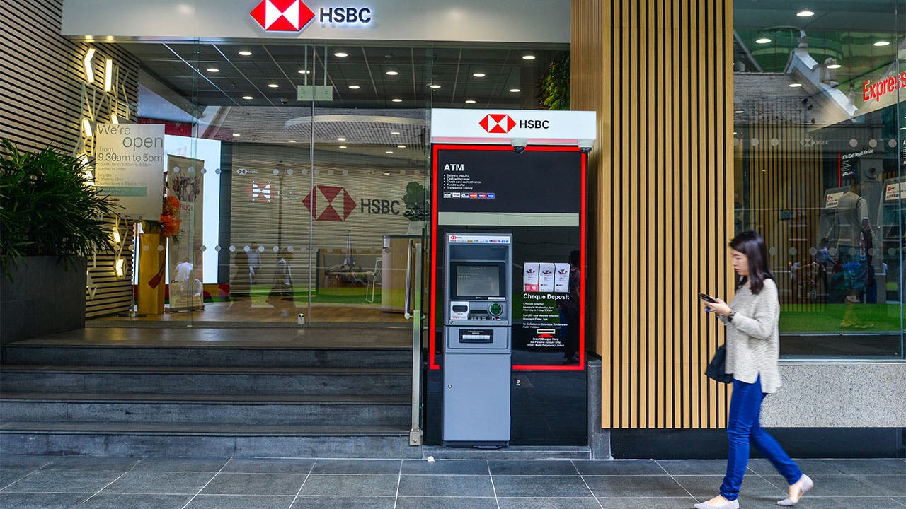 HSBC woman walking past bank