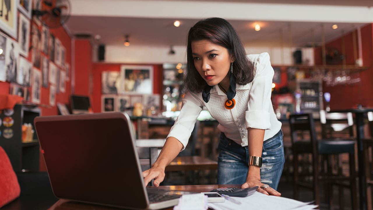 Woman entering receipts online on her business account