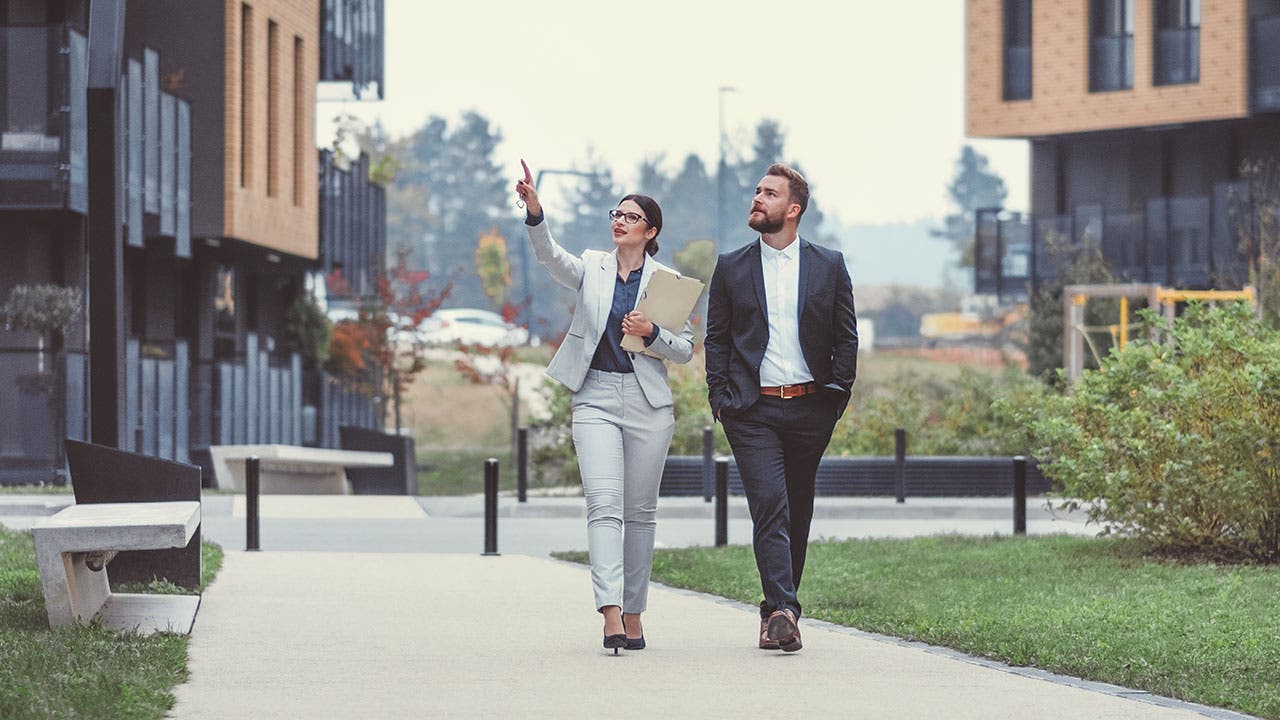 Real Estate Agent showing apartment complex