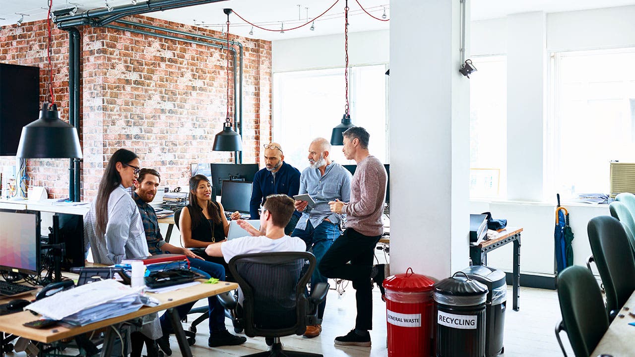 Coworkers talking about FIRE in open office