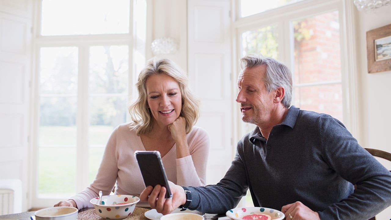 Couple looking at bank app on phone
