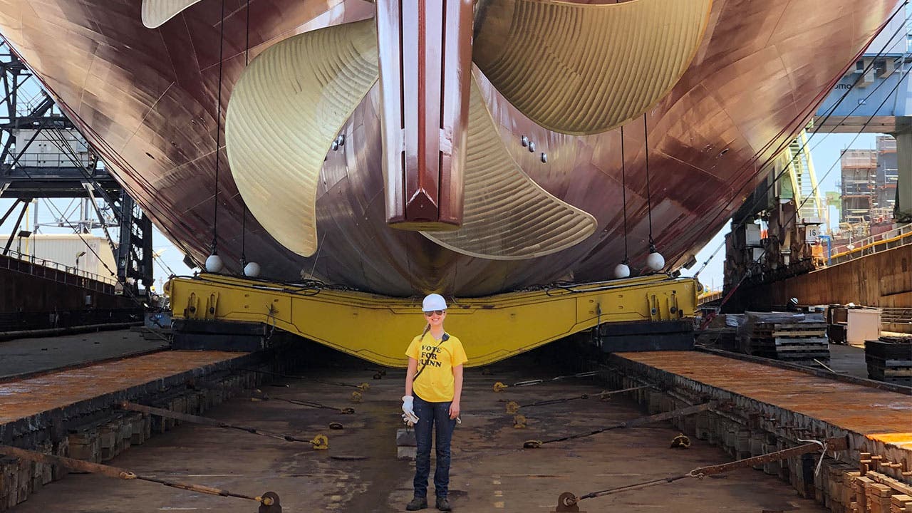 University of Michigan student Anika Szuszman, National Steel and Shipbuilding Co. intern, in front of the Matson, Lurline that will sail the West Coast.