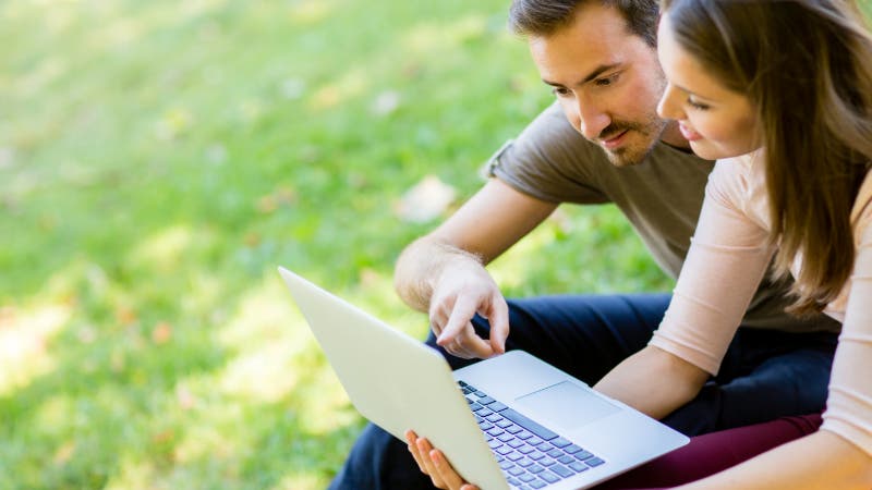 Couple outside with laptop