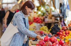 woman picking produce at grocer