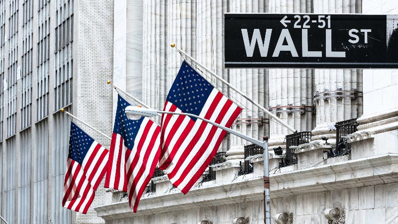 US flags fly outside the NYSE building on Wall Street