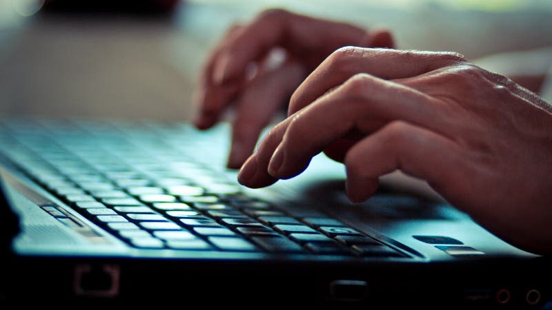 women typing on computer