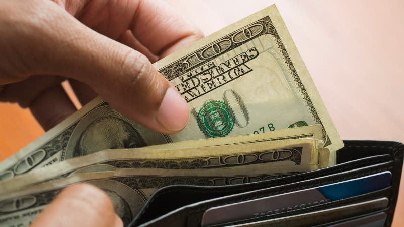 man taking money out of wallet