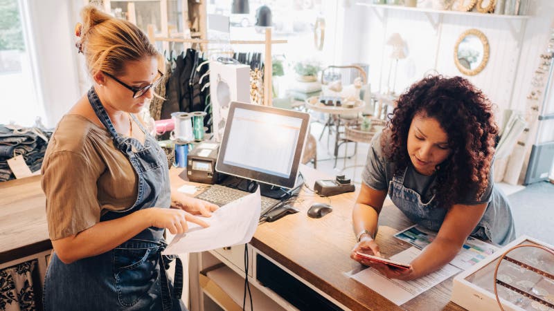 colleagues discuss financial receipts checkout