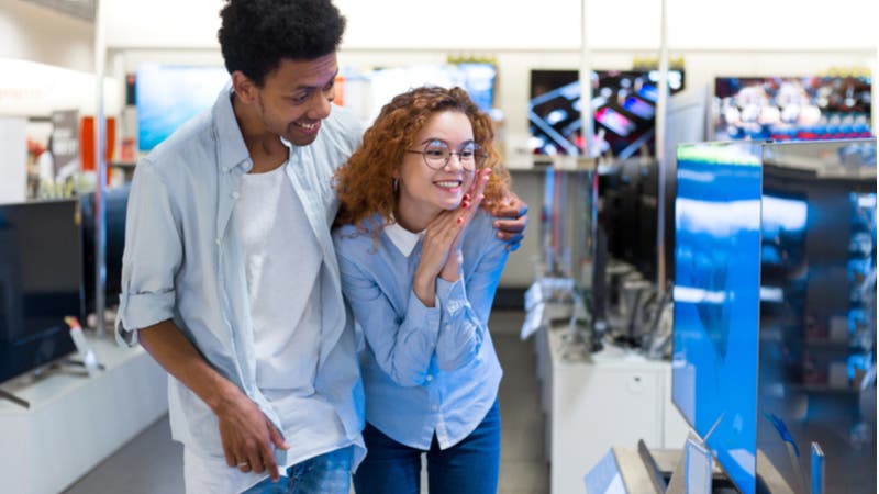 Young couple shopping for TV