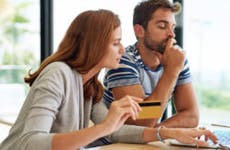 Couple looking at computer with credit card