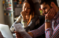 Stressed couple looking at bills