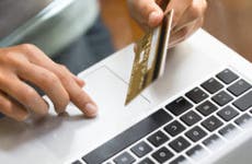 Person on laptop with credit card