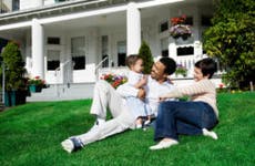 Mixed-race family in front of a house