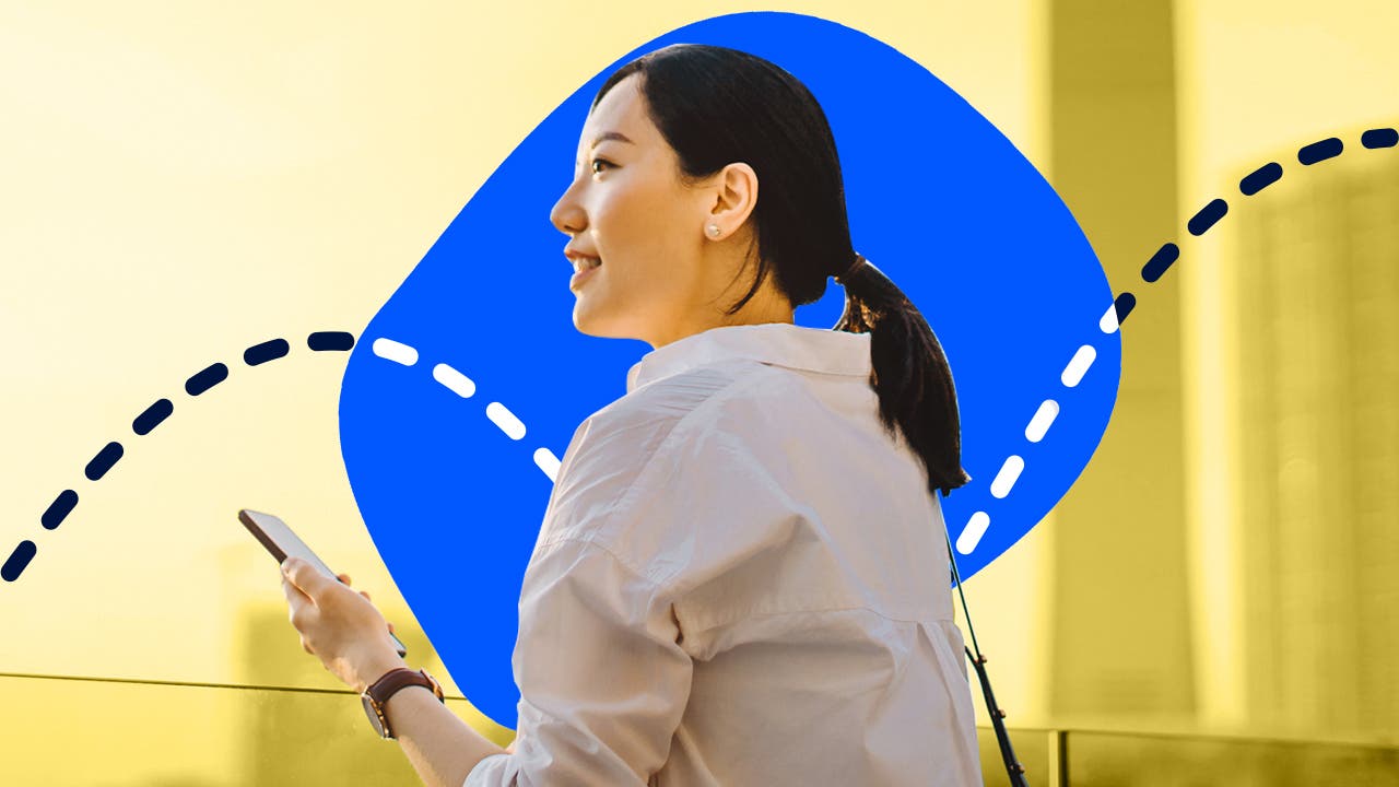 An Asian woman looks hapy against a blue and yellow background